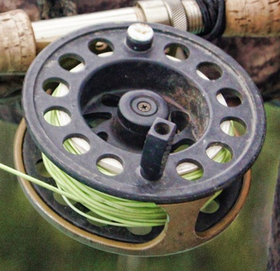 Fly reel with green fly line